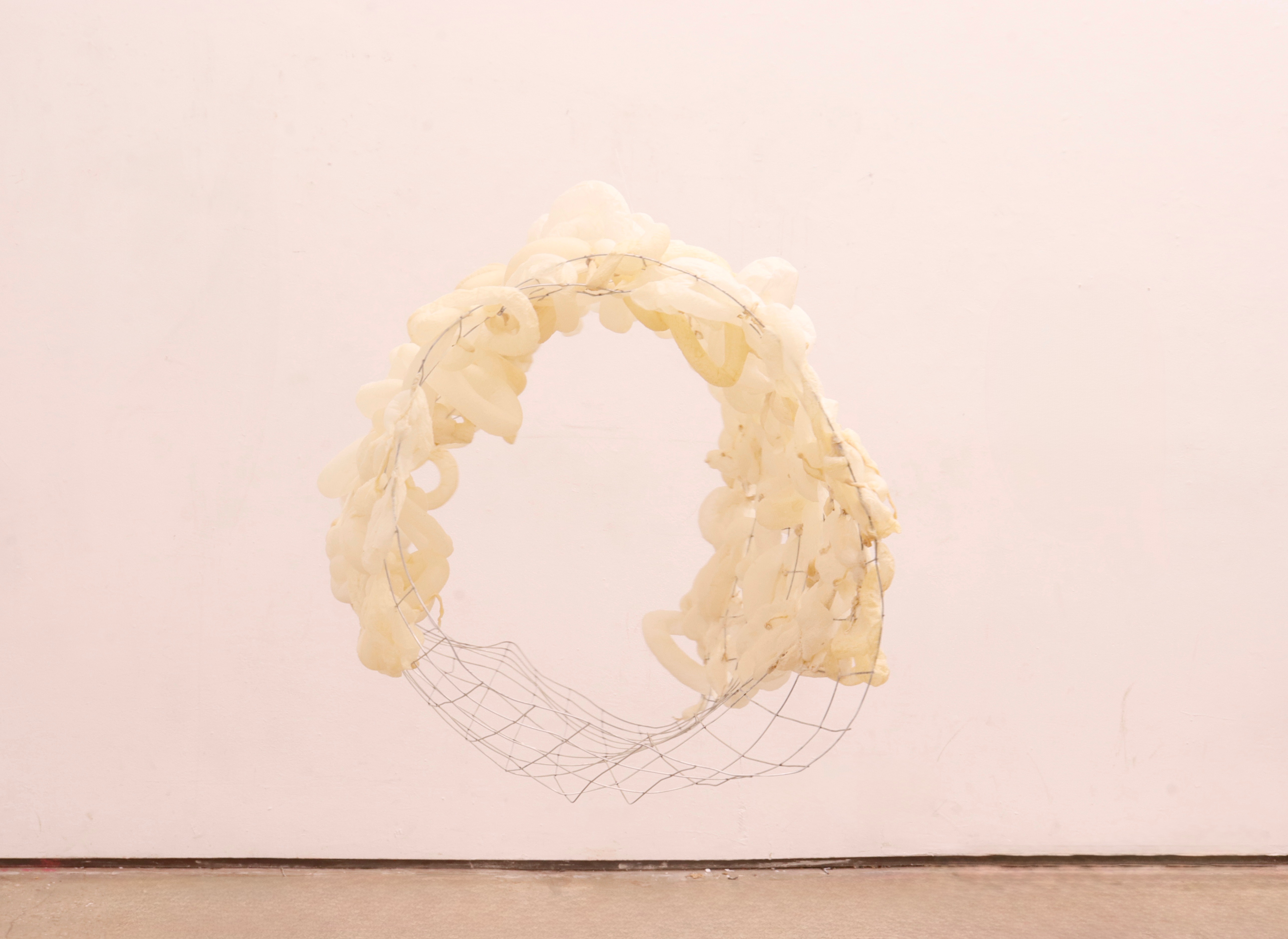 Held at the Edge sculpture by oneg - organic material and rigid framework